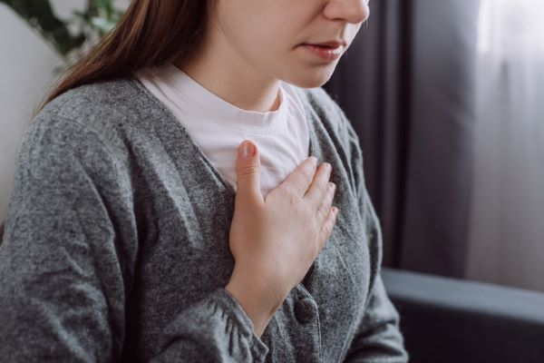 lady with hand to chest