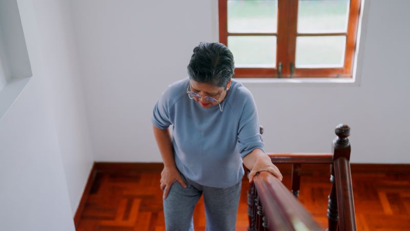 woman walking up the stairs slowly